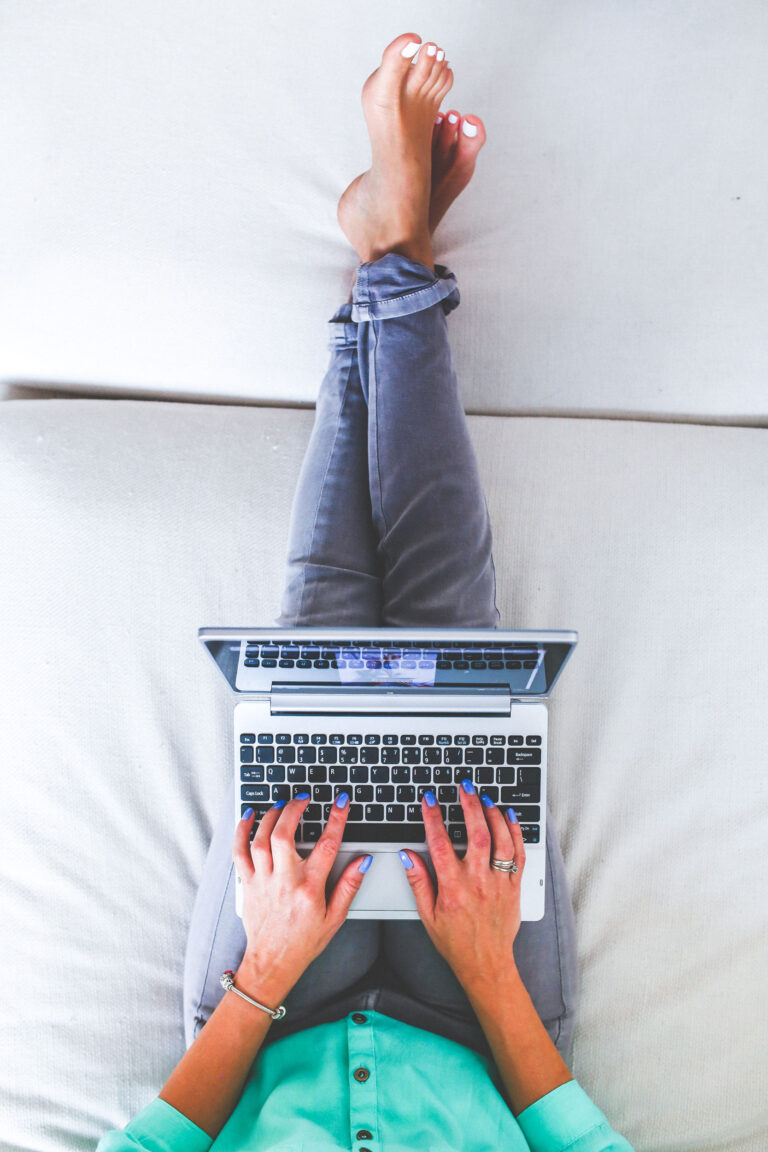 woman-lying-and-typing-on-laptop-web